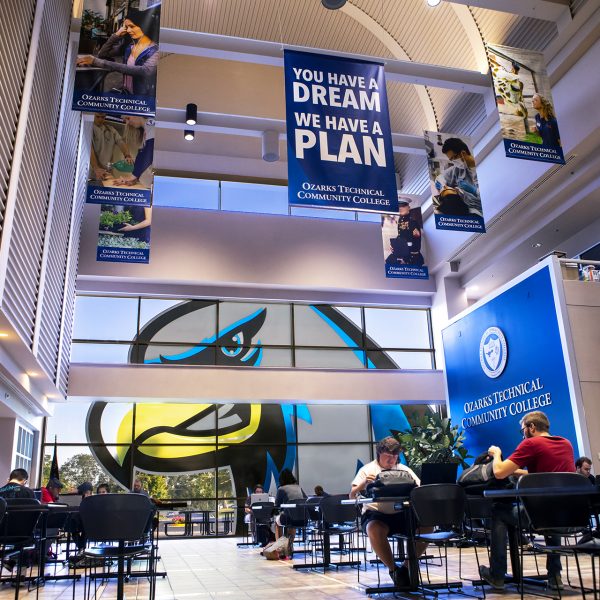 Jared Atrium with students studying and Ozzy the Eagle logo in the window.