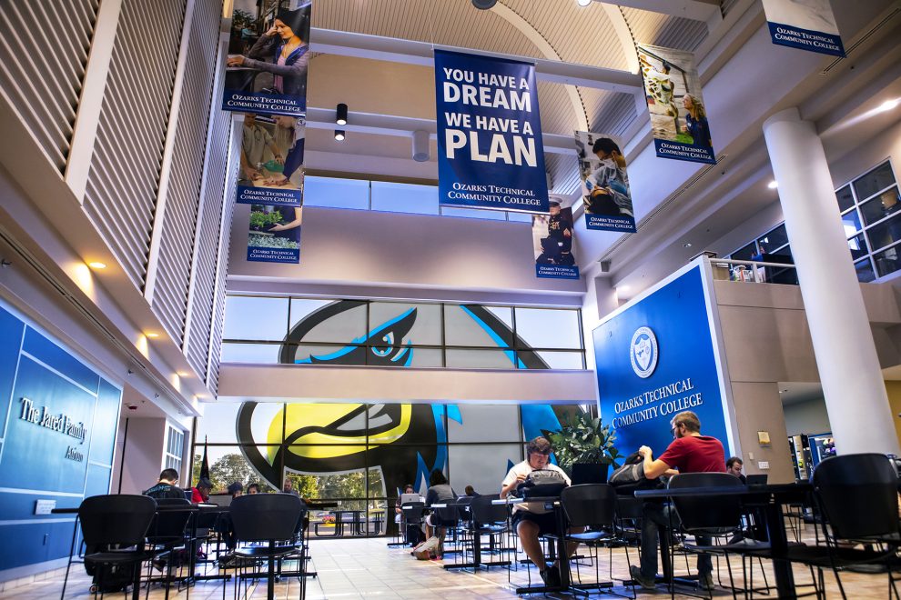 Jared Atrium with students studying and Ozzy the Eagle logo in the window.