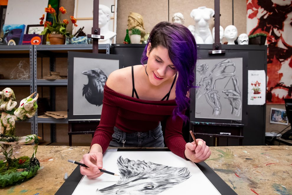 Fine Arts student finishes a drawing of a bird.