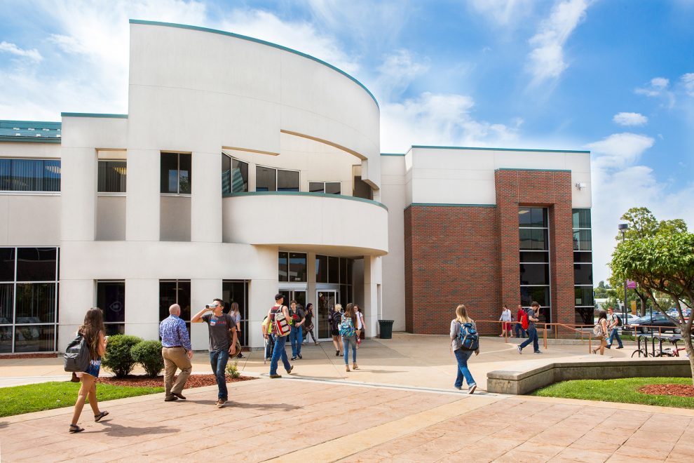 Students and employees walking in front of Norman K Meyers building.