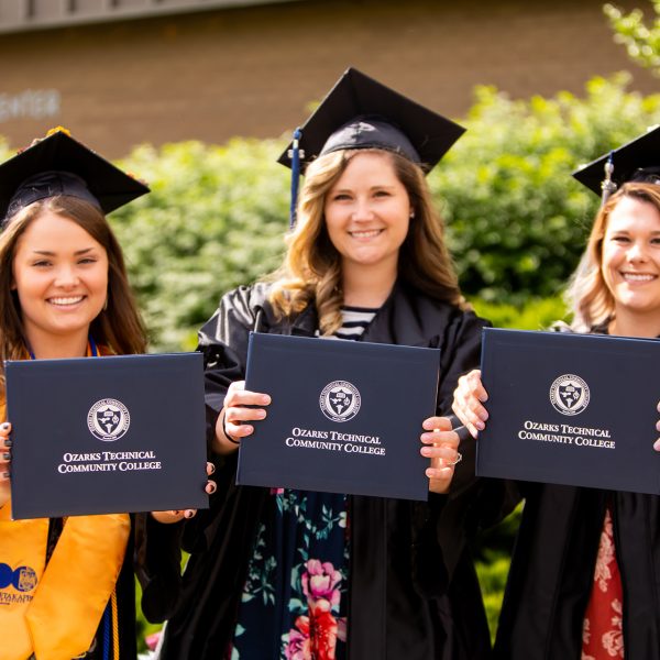 OTC graduates present their diplomas.