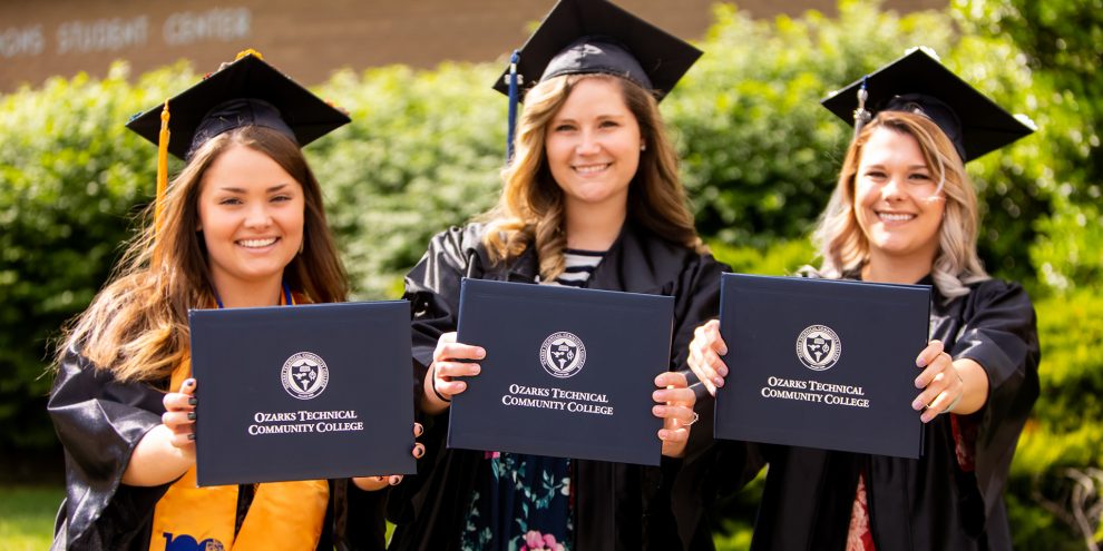 OTC graduates present their diplomas.