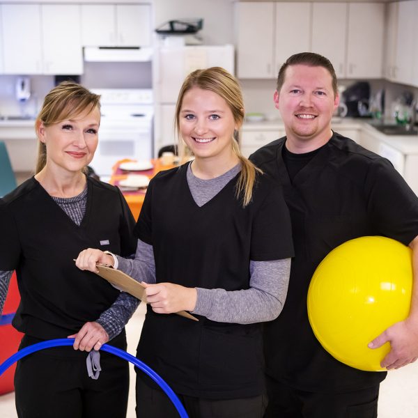 Three Occupational Therapy Program students smile at the camera.