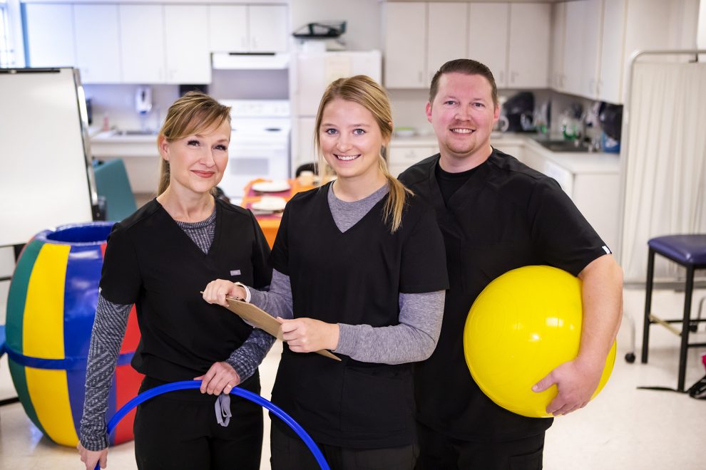 Three Occupational Therapy Program students smile at the camera.