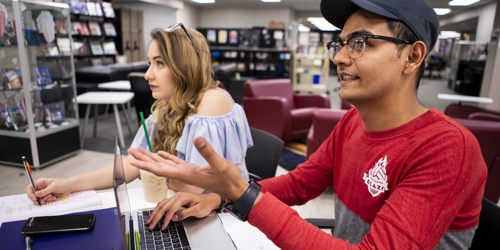 Two students studying in the Hamra Library.