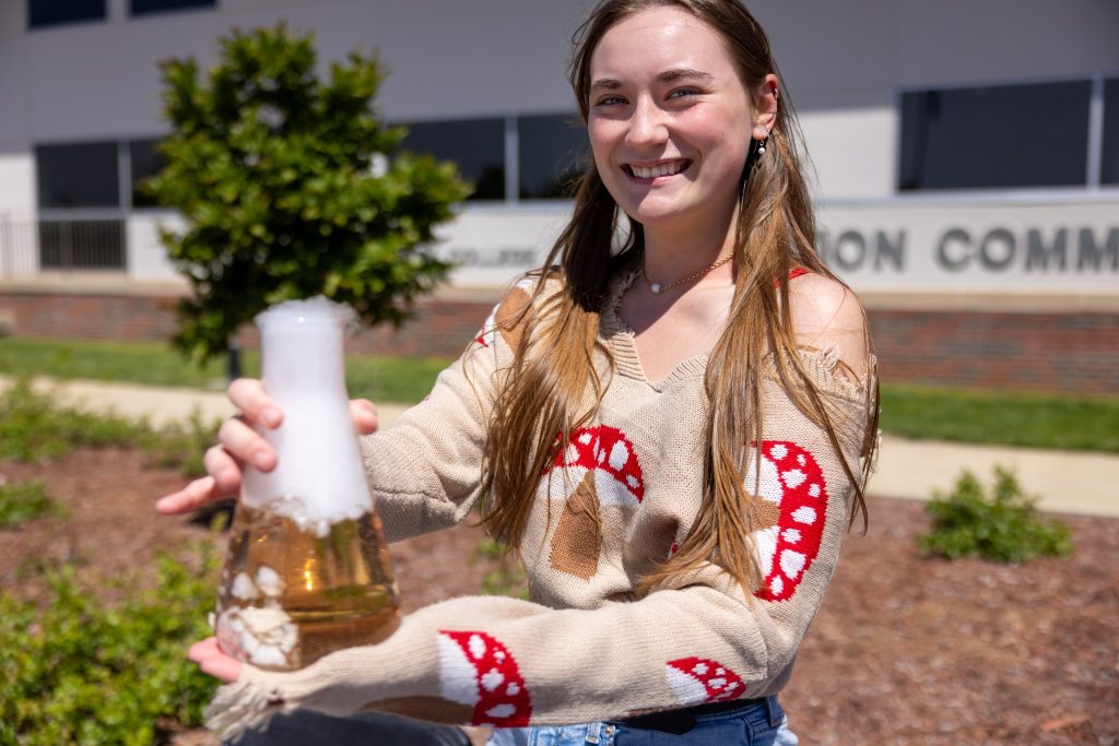 student with beaker