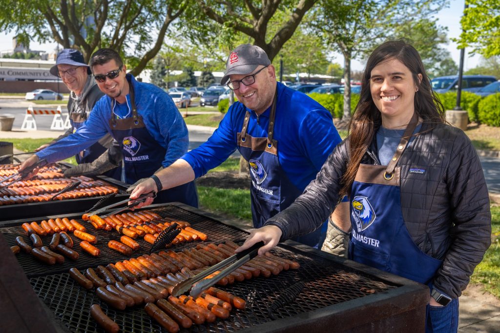 Volunteers grilling hot dogs for the semi-annual picnic